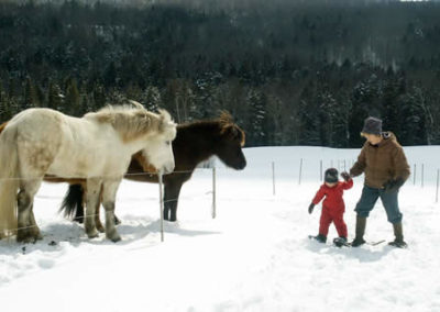 June Explains the Finer Points of Snowshoeing to Isabelle | Vermont Horse Farm & Vacation Rental in Fayston, Vermont